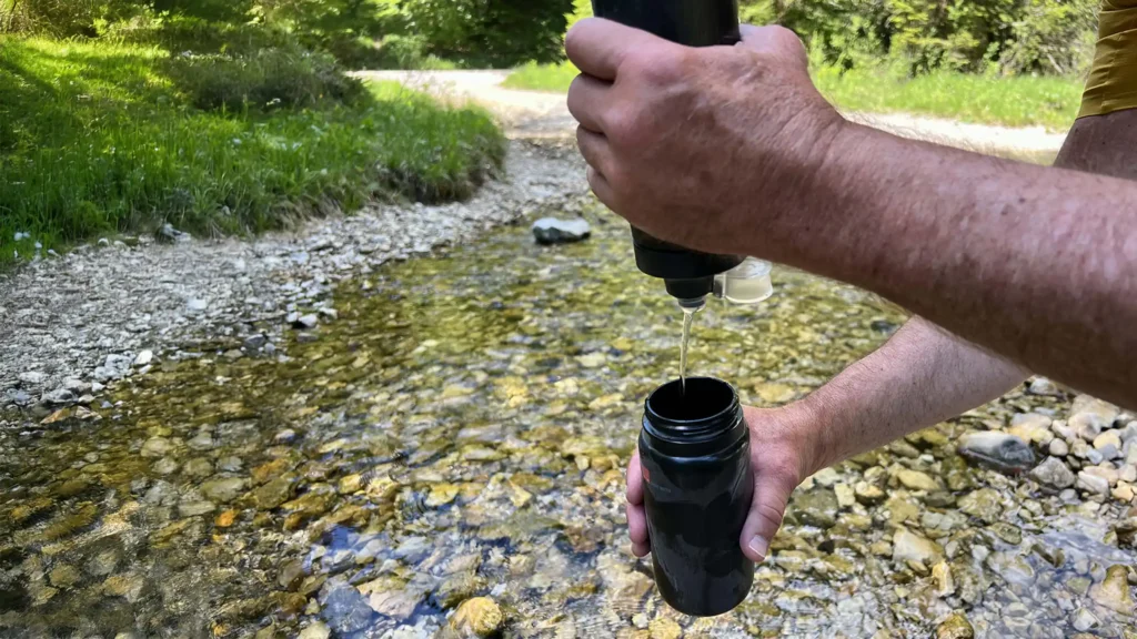 Filtering water from a stream using the Katadyn BeFree AC Bottle portable water filter.