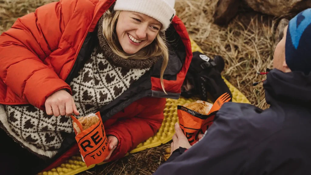 Hikers enjoying a freeze-dried meal during an outdoor adventure.