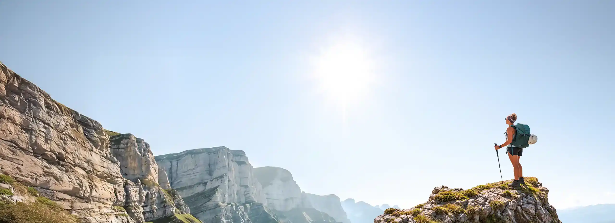 Hiker with backpack standing on a mountain ridge at sunrise, Lyocorner outdoor gear and nutrition